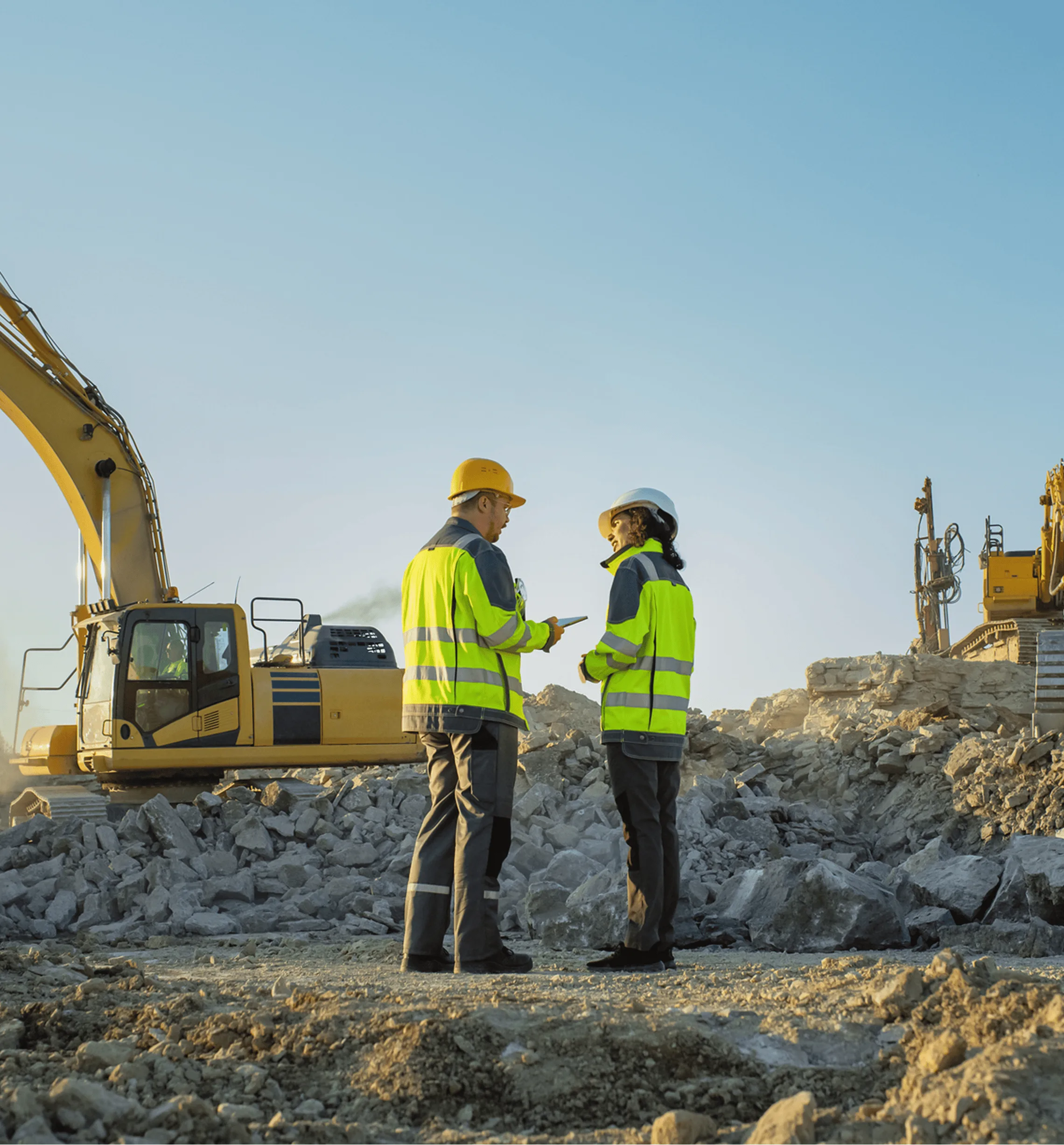 Two construction professionals in safety gear on a jobsite