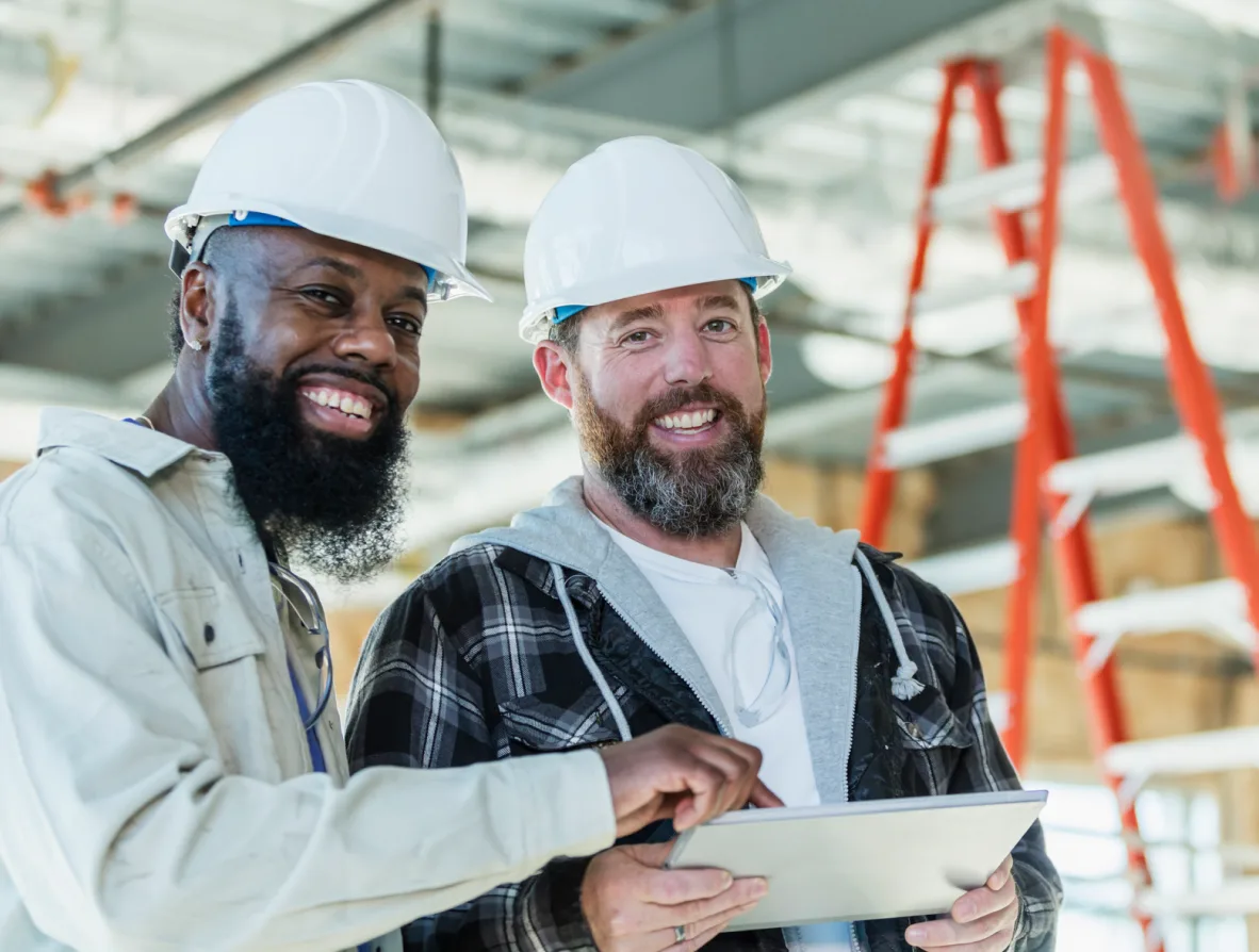Two contractors working on an ipad